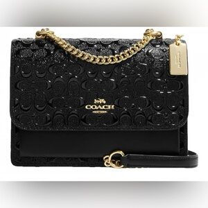 Coach Klare Crossbody bag. It is made of black signature patent leather.